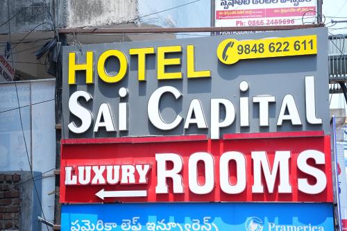 a sign for a hotel sat capital luxury rooms at Hotel Sai Capital in Vijayawāda