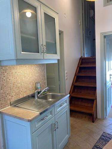 a kitchen with a sink and a staircase at EnjoyPatmos in Skala