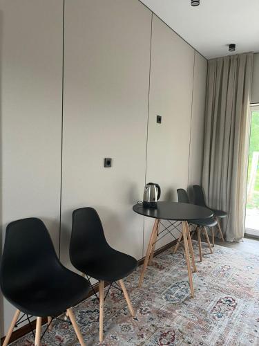 a row of chairs and a table in a room at Алаша in Qotanqaraghay