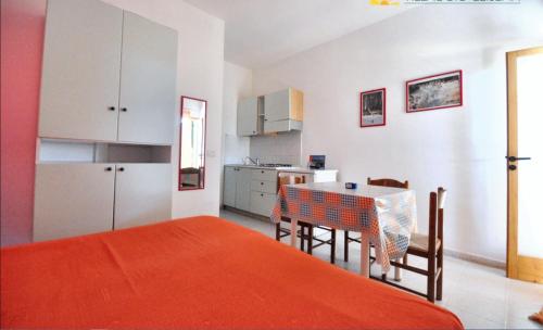 a kitchen and dining room with a table and chairs at Charming Studio in Vieste, 25 m², Shared Pool in Vieste