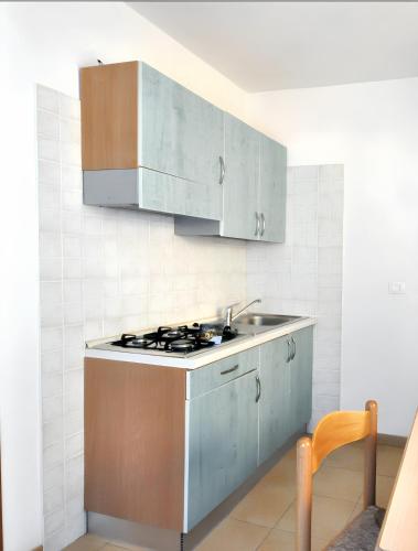 a kitchen with a sink and a stove top oven at Charming Studio in Vieste, 25 m², Shared Pool in Vieste