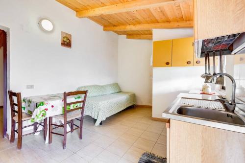a kitchen with a sink and a table and a couch at Charming apartment in Pisciotta, 37 m² with terrace in Pisciotta