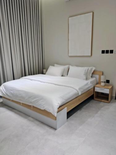 a bedroom with a large bed with a frame at شاليهات ترف in Abha