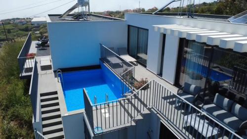 an aerial view of a house with a swimming pool at CASA PANORAMA SOL- NEW VILLA WITH HEATED SALTWATER POOL and FANTASTIC SEA VIEW in Ponta do Sol