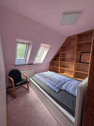 a bedroom with a bed and a chair at Tischlerei in Barum