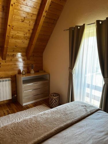 a bedroom with a bed and a window at Hanovi Apartments in Borje