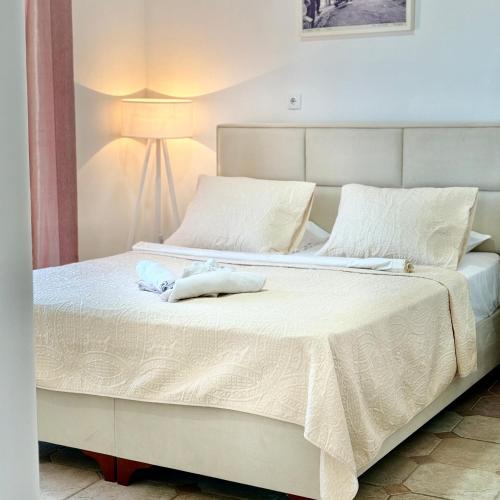 a bedroom with a bed with two pillows on it at Villa Guci in Ulcinj