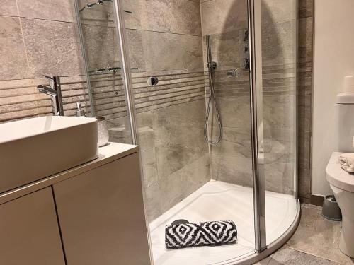 a bathroom with a shower and a sink at Central City stays in Exeter
