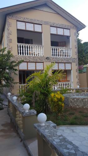a house with a stone bench in front of it at Comfortable apartment in Baie Sainte Anne 56 m² with sea view in Baie Sainte Anne