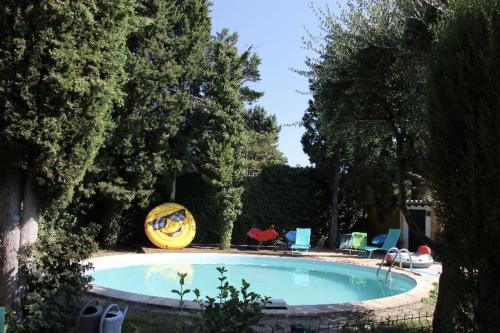 a swimming pool in a yard with trees at Villa avec piscine à Saze in Saze