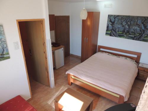 a small bedroom with a bed and a table at Modern Studio with Sea View - Ulcinj - 25 m² - Balcony in Ulcinj