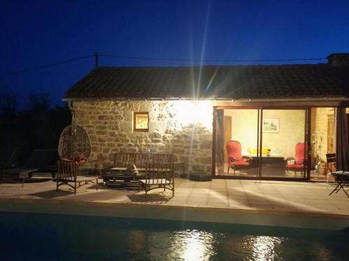 a patio with chairs and a table next to a pool at Studio charmant à Bio avec jardin et piscine partagée, 32 m². in Bio