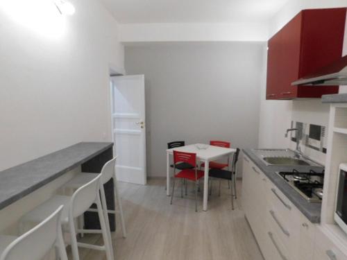 a small kitchen with a table and chairs in it at Contemporary Apartment in Trapani, 50 m² with Balcony in Trapani