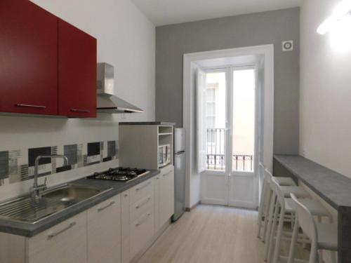 a kitchen with a sink and a stove top oven at Contemporary Apartment in Trapani, 50 m² with Balcony in Trapani