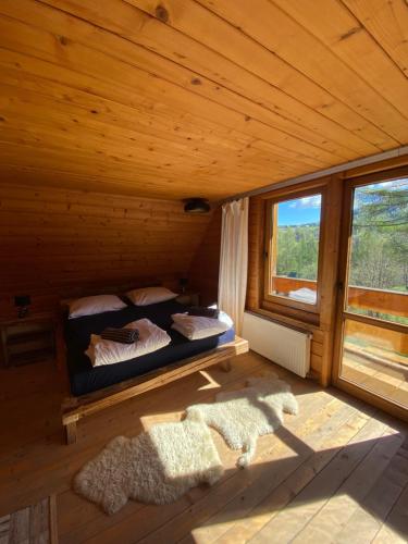 a bedroom with a bed in a wooden cabin at 650m n.p.m. in Zawoja
