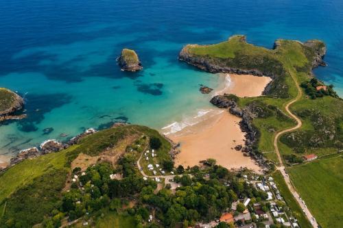 an aerial view of a beach and the ocean at Kampaoh Playa Troenzo in Celorio