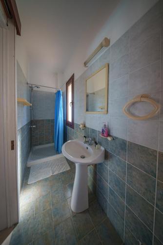 a bathroom with a white sink and a shower at Ocean Breeze Club-Villa Mare in Kato Yialia