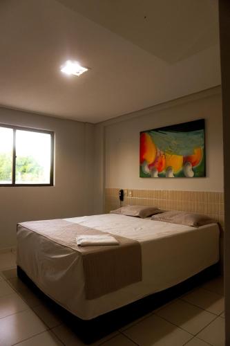 a bedroom with a large bed in a room at Hotel Tupinambá Timon in Timon