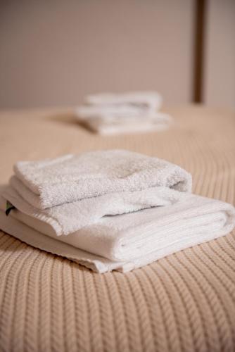a stack of towels sitting on top of a bed at Hotel Taurus in Solotvyno
