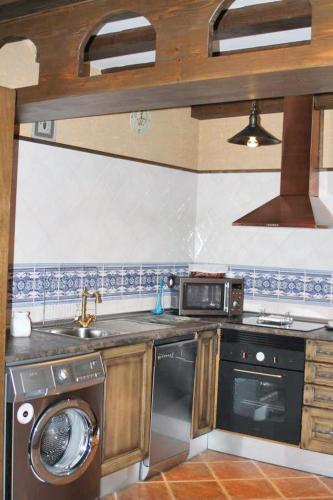 a kitchen with a washer and a sink and a dishwasher at Family Apartment with Mountain View in Hueva in Hueva