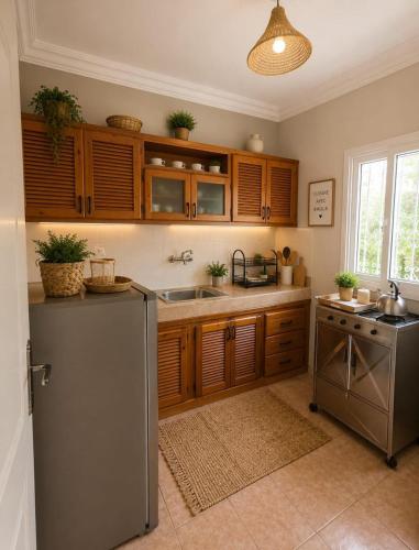 a kitchen with wooden cabinets and a stainless steel refrigerator at Rayhane-26 in Al Ghar