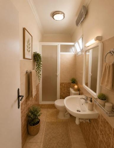 a bathroom with a toilet and a sink at Rayhane-26 in Al Ghar