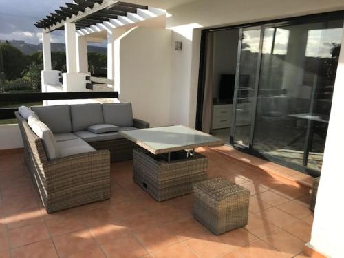 a living room with a couch and a table at Spacious Apartment with Views in Málaga, 77 m², Shared Pool in San Luis de Sabinillas