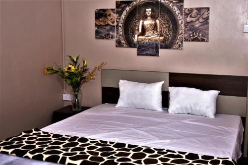 a bedroom with a bed with three paintings on the wall at Modern Apartment with Garden and Lake View in Riambel in Riambel