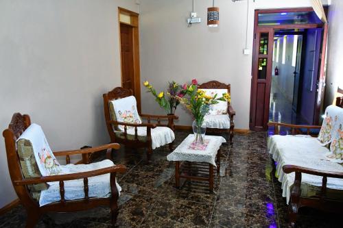 a room with chairs and a table with a vase of flowers at Modern Apartment with Garden and Lake View in Riambel in Riambel