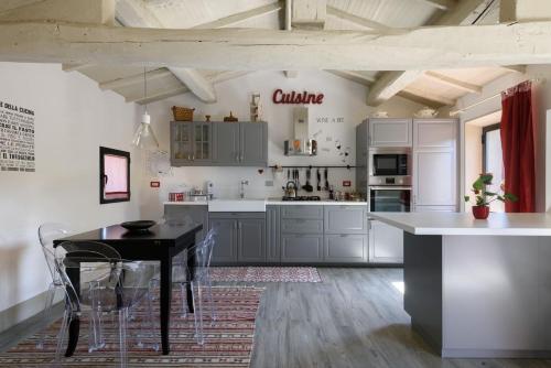 a kitchen with a table and chairs in a room at Charming House in Trequanda with Shared Pool in Trequanda