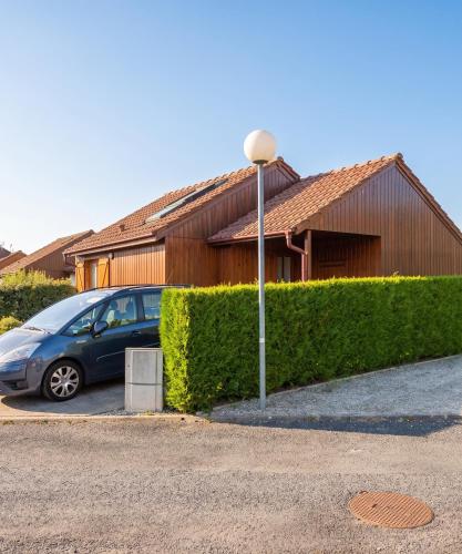 a blue car parked in front of a building at Chalet confortable à Giffaumont-Champaubert avec terrasse in Giffaumont-Champaubert