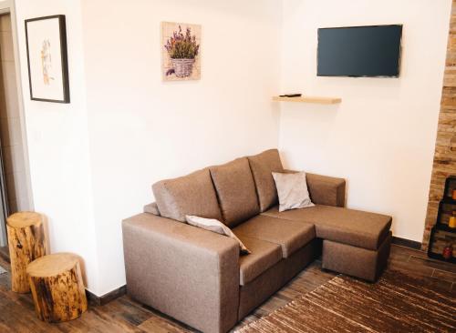 a brown couch in a living room with a tv at Charming House in Sistelo + View in Sistelo
