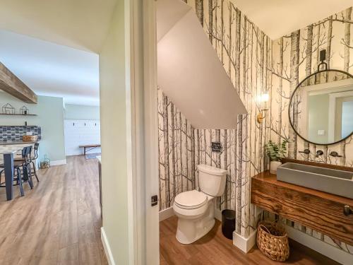 a bathroom with a toilet and a sink and a mirror at Modern Stunning Private Flat Lakefront in Oakland