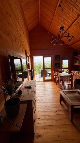 a living room with a table and a dining room at Babia Góra View House in Kocierz Moszczanicki
