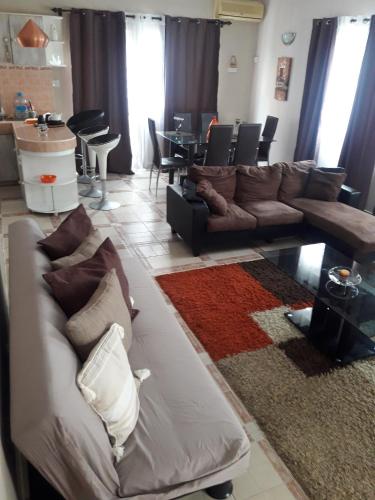 a living room with a couch and a table at Modern Apartment in Melville, Pool View, 120 m² in Grande Gaube