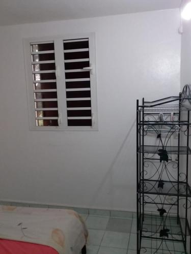 a room with a white wall and a window at Maison accueillante aux Mangles avec jardin clôturé in Les Mangles
