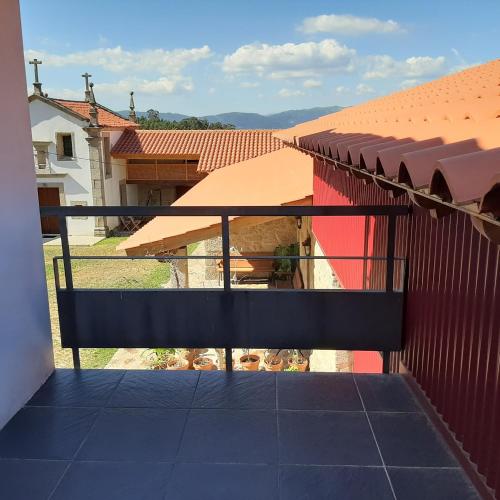 a balcony with a view of a house at Beautiful villa in Póvoa de Lanhoso with pool and garden in Póvoa de Lanhoso