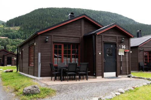 a building with a table and chairs in front of it at Lake Cabin with Fireplace in Åre