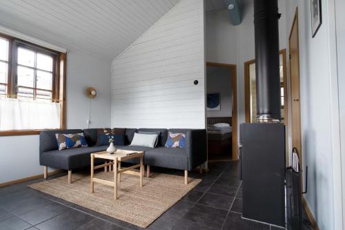 a living room with a couch and a table at Lake Cabin with Fireplace in Åre