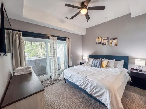 a bedroom with a bed and a ceiling fan at New Luxury Lakefront Walk to Wisp in McHenry