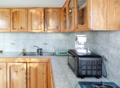 a kitchen with a coffee maker on top of a microwave at Spacious Apartment in Calodyne with Enclosed Garden in Calodyne