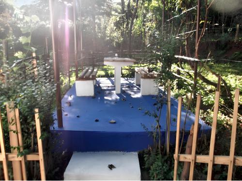 a playground in a garden with a blue surface at Cozy House in Jazvine with Garden in Jazvine