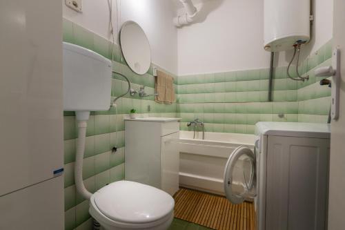 a bathroom with a toilet and a sink at Apartman Kika Knjaževac in Knjazevac.