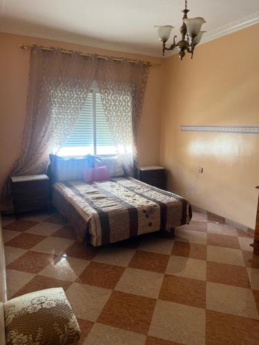 a bedroom with a bed in front of a window at Hrich house in Fnidek