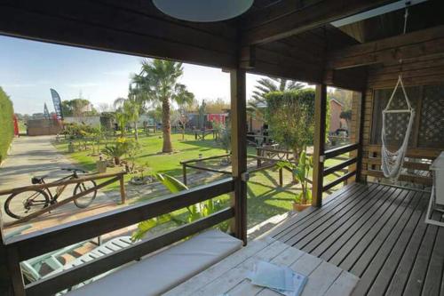 an outdoor deck with a swing and a playground at Charming bungalow in Tarifa with mountain view and garden in Tarifa