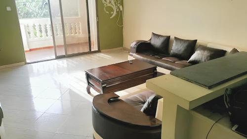 a living room with leather couches and a table at Stylish apartment in El Marsa 75 m² sea view in El Marsa