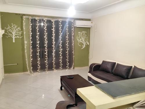 a living room with a couch and a table at Stylish apartment in El Marsa 75 m² sea view in El Marsa