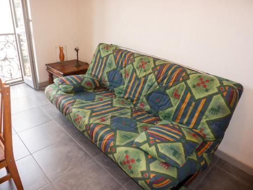 a couch sitting in a living room with at Appartement cosy à Bonifacio avec vue sur la mer - 45 m² in Bonifacio