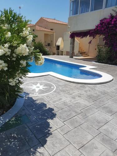 a swimming pool in front of a building at Seaside Villa in Calafat with Private Pool. in Calafat