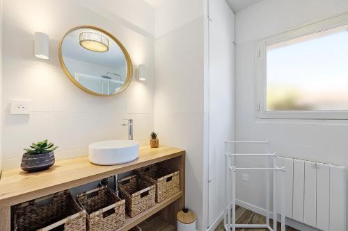 a bathroom with a sink and a mirror at L'Epine Bleue in LʼÉpine